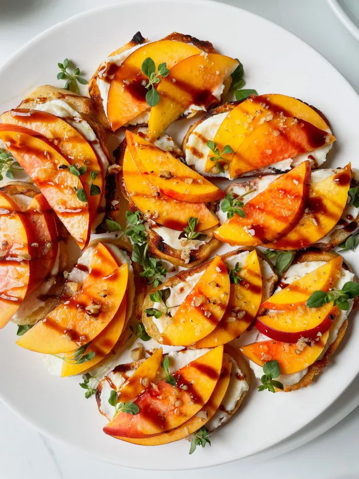 Grilled Peach & Goat Cheese Crostini with Sweet Heat Drizzle